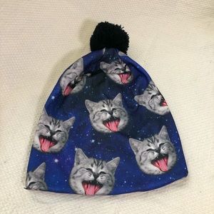Novelty pom-pom beanie with blue and pink Space Cat print
